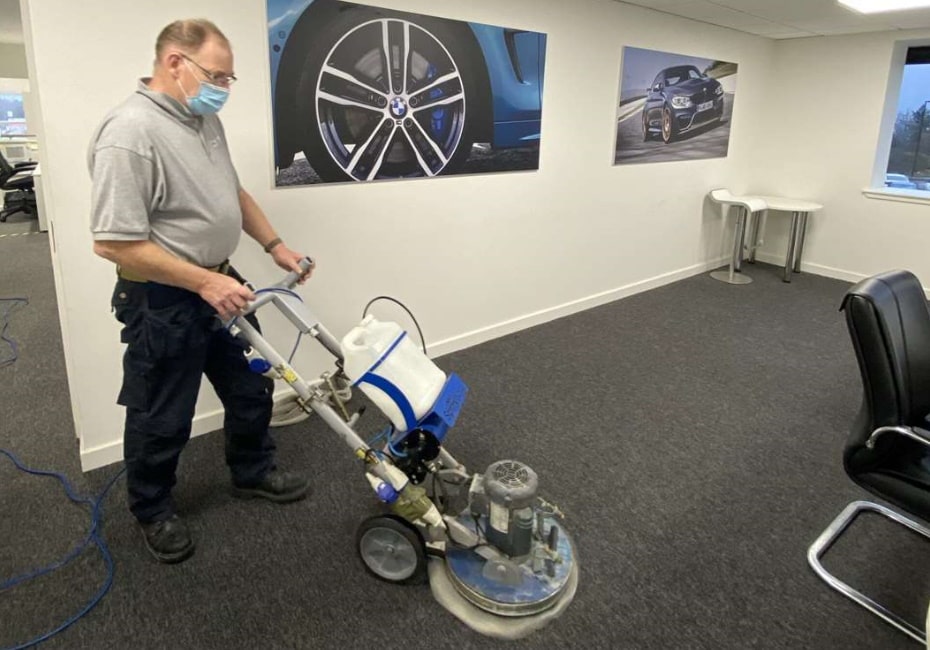 Paul Dyson cleaning office carpets with professional carpet shampooer