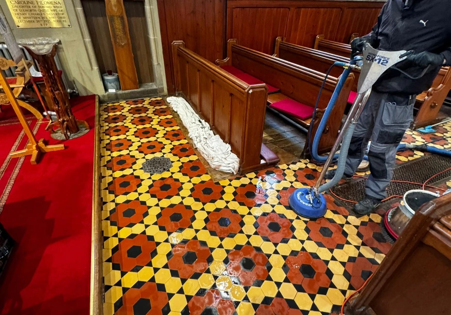 A professional cleaner cleans colourful tiles.