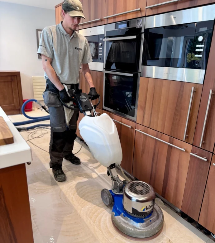 A member of the Paul Dyson team diamond polishing a kitchen floor.