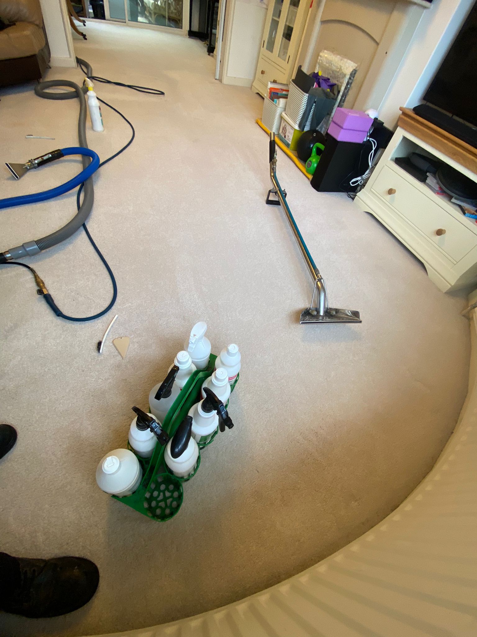 An array of specialist floorcare equipment on a residential home's cream-coloured carpet.