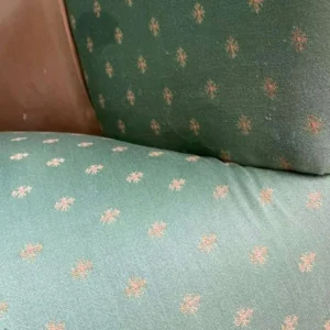 A pale blue patterned sofa after stain removal treatment.